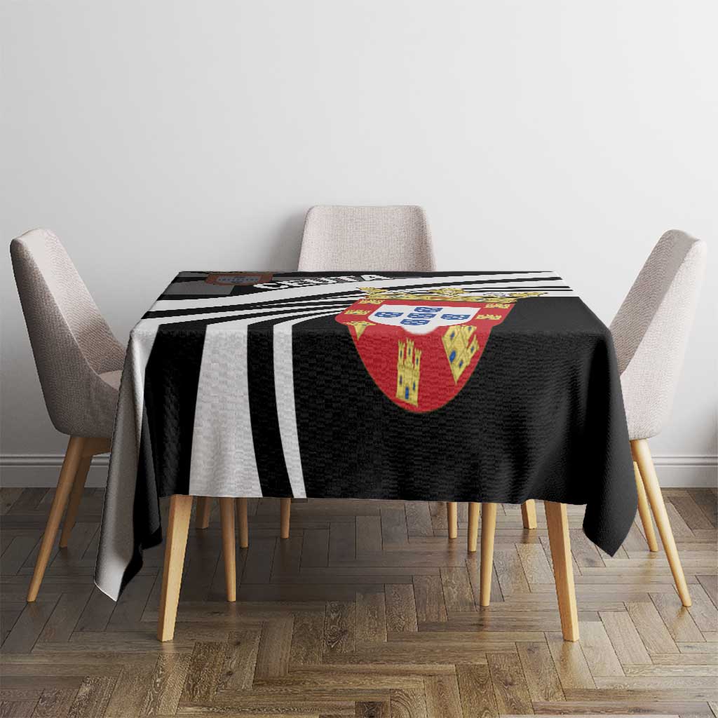 Black tablecloth on dining table featuring bold black-and-white stripes and crest emblem.