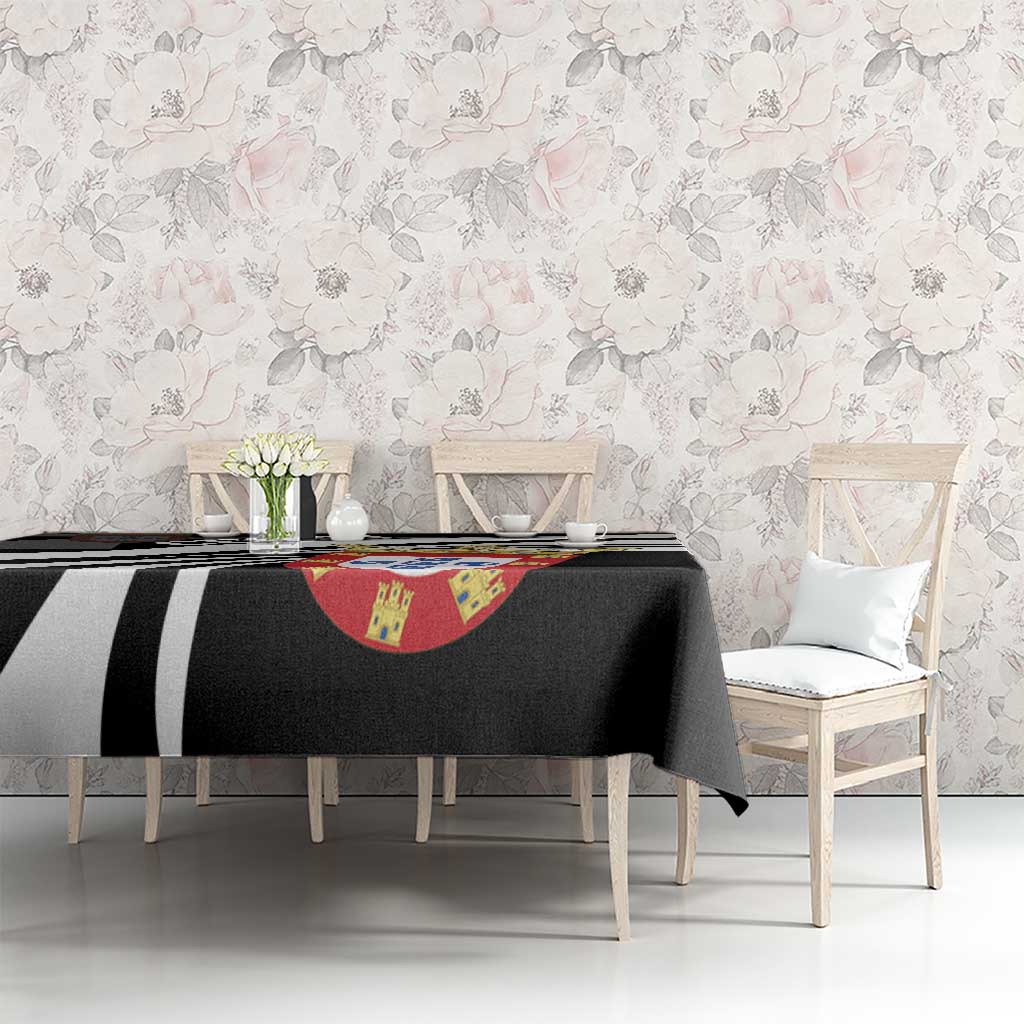 Black tablecloth covering dining table with black-and-white stripes and crest centerpiece graphic.