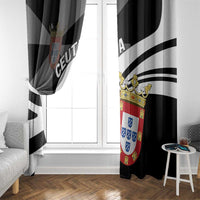 Black and white day window curtain with shield crest, hanging at a window