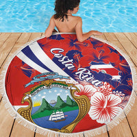 Round red beach blanket coat with white-blue crest and hibiscus flowers, fringed border