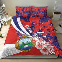 Costa Rica bedding set with red base, blue hibiscus pattern, and coat-of-arms panel