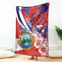 Hanging red blanket throw with Costa Rica coat of arms, hibiscus flowers, and diagonal stripe