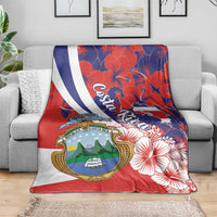 Red blanket with Costa Rica emblem, white-blue diagonal stripe, and hibiscus flower print