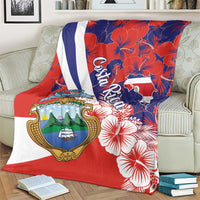 Red blanket with white-and-blue diagonal stripe, Costa Rica coat of arms and hibiscus print