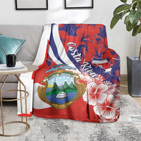 Red blanket-style throw with Costa Rica crest, hibiscus flowers, and white-blue flag stripe
