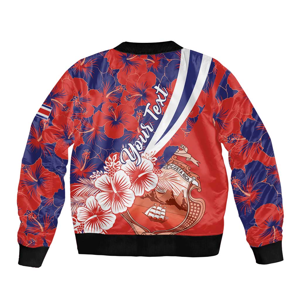 Red and navy bomber jacket, hibiscus print on back, coat of arms graphic, black ribbed cuffs