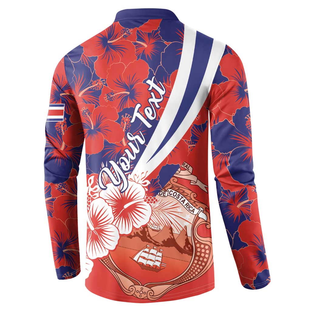 Red and navy long-sleeve button sweatshirt with hibiscus pattern and crest graphic on back