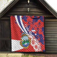 Red, blue, white quilt blanket with Costa Rica crest, white stripe, hibiscus flowers