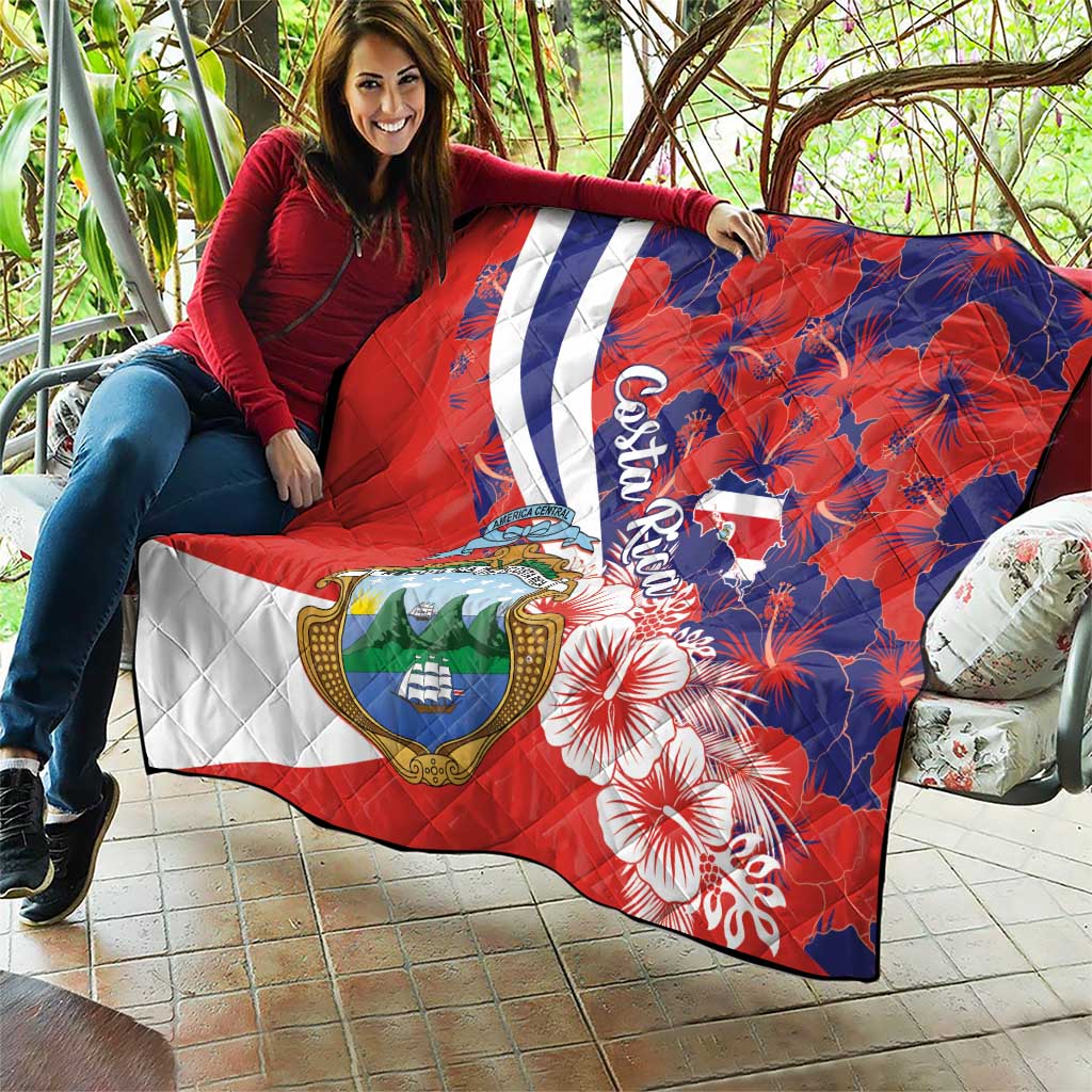 Red, white, and blue quilt blanket with Costa Rica crest, white stripe, hibiscus pattern