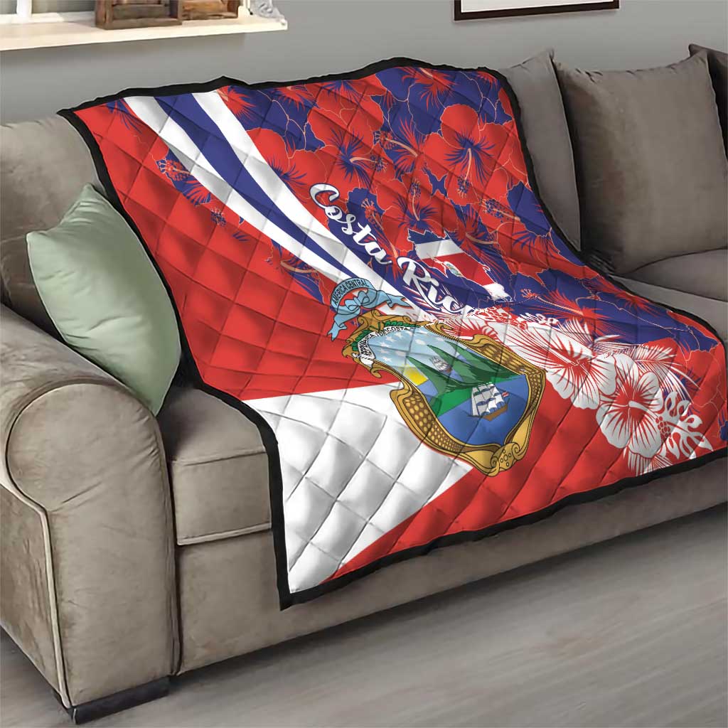 Red and blue quilt blanket with white stripe, Costa Rica crest, and hibiscus flowers