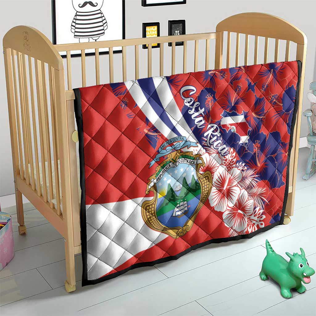 Quilt blanket with red, white, and blue blocks, Costa Rica crest, hibiscus flower pattern