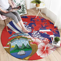 Round red rug with Costa Rica crest, hibiscus blossoms, and blue-white stripe design