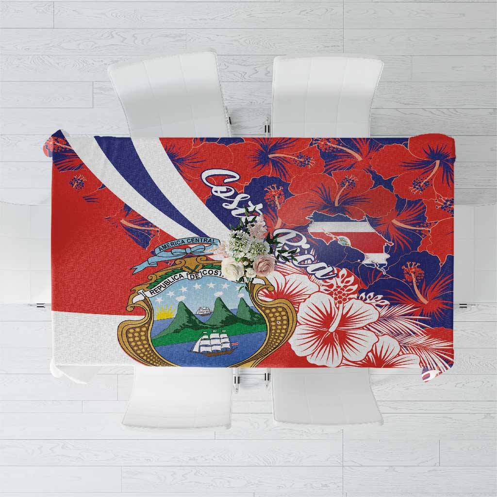 Red tablecloth with blue hibiscus flowers and crest motif