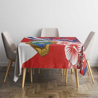 Red tablecloth with hibiscus flowers and crest emblem on dining table