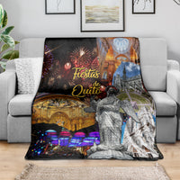 Ecuador blanket draped over a sofa, showing fireworks, cathedral arches, and a standing figure print