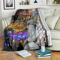 Ecuador blanket over a couch with colorful night scenes, fireworks, and a standing statue illustration