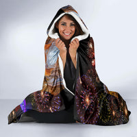 Hooded blanket with black and orange fireworks print, sherpa-lined hood and sleeves
