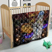 Ecuador quilt on crib, black throw with “Fiestas de Quito,” fireworks, cathedral and figure