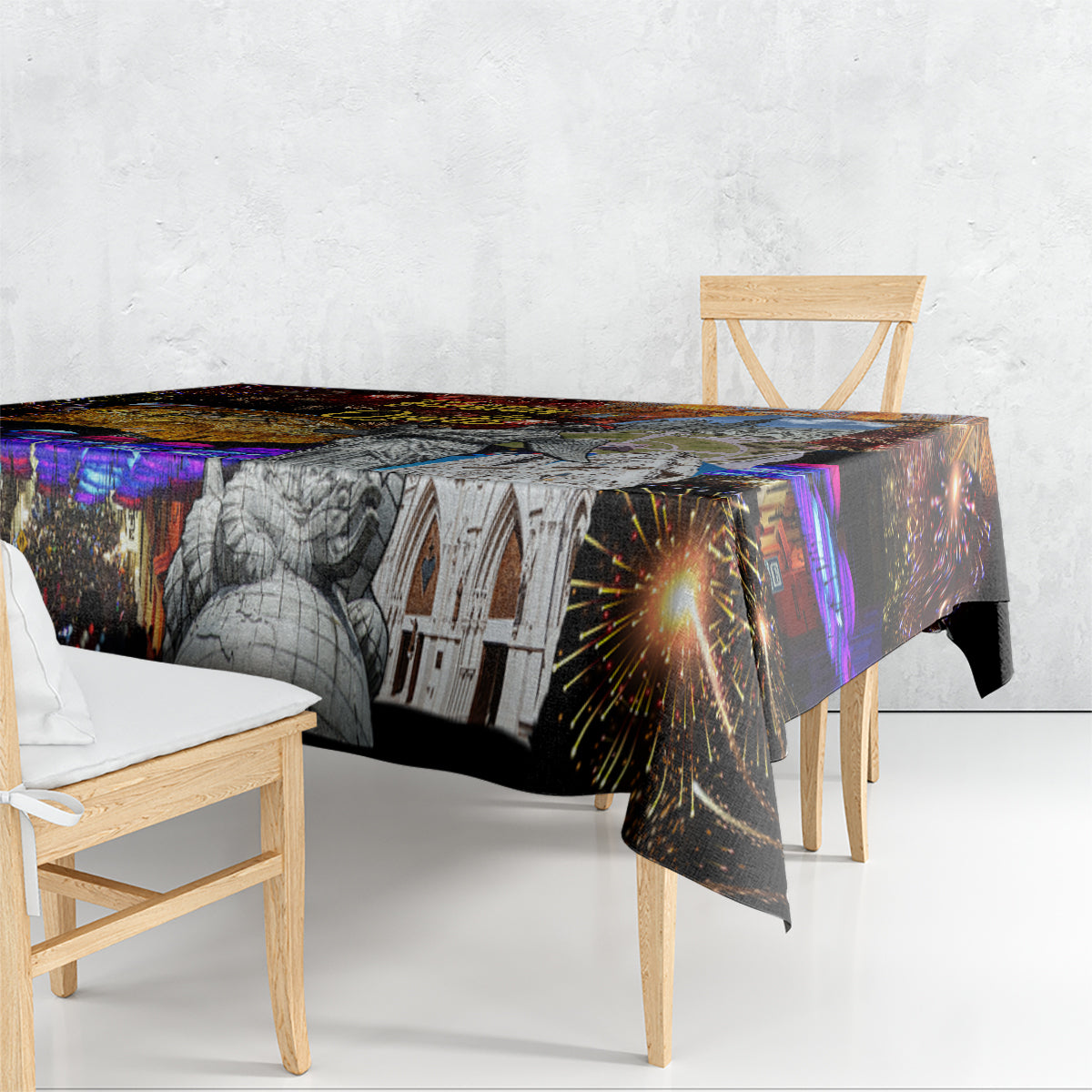 Rectangular tablecloth draped over table edge with fireworks and grayscale statue/buildings