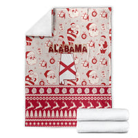 Folded Alabama holiday blanket with Santa and state flag motif, red and white pattern