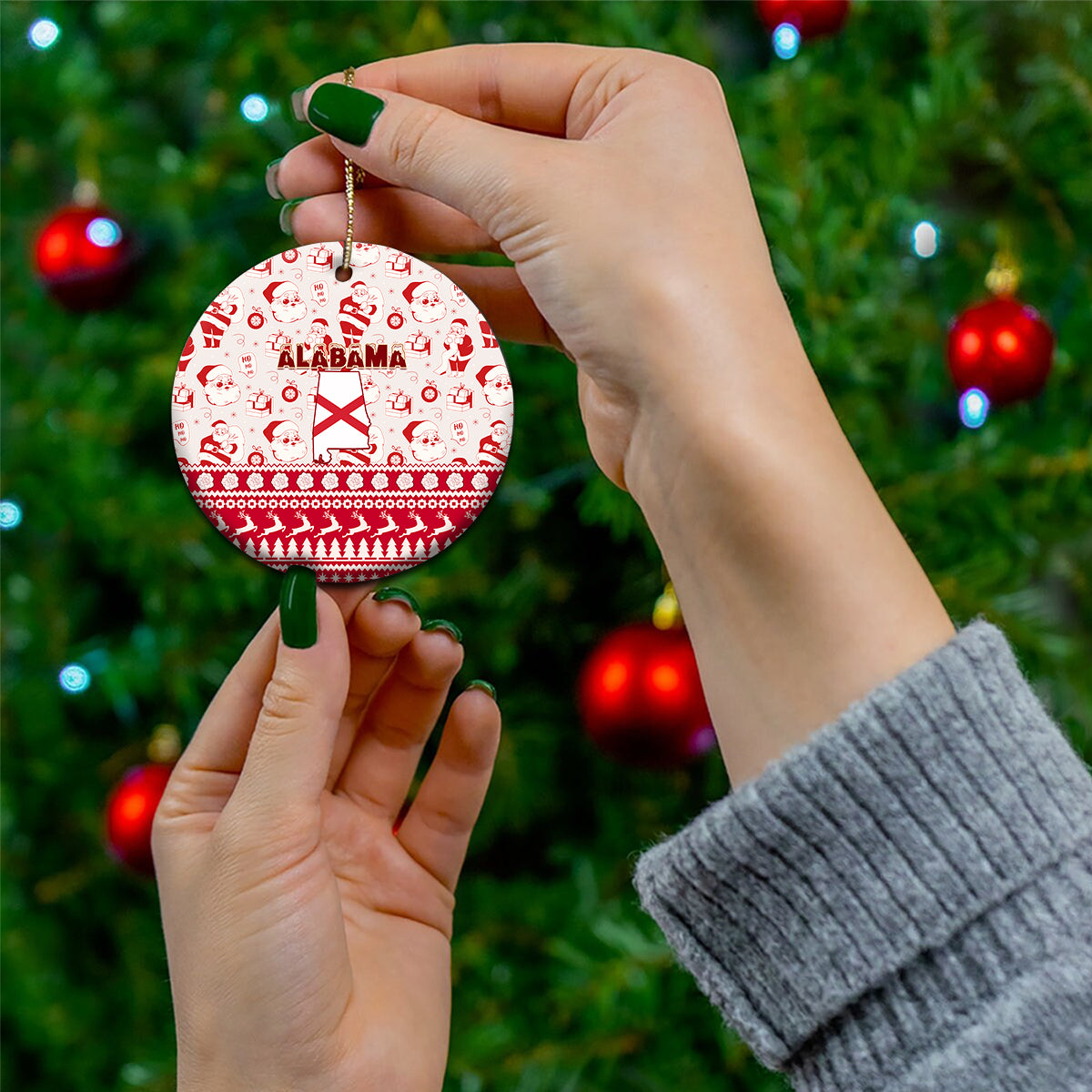 Red round ceramic Alabama Christmas ornament with Santa pattern and hanging gold cord.