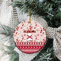 Red round ceramic Alabama Christmas ornament with Santa pattern on a tree branch.
