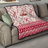 Red and white Alabama Christmas quilt on a sofa with Santa print and Alabama text