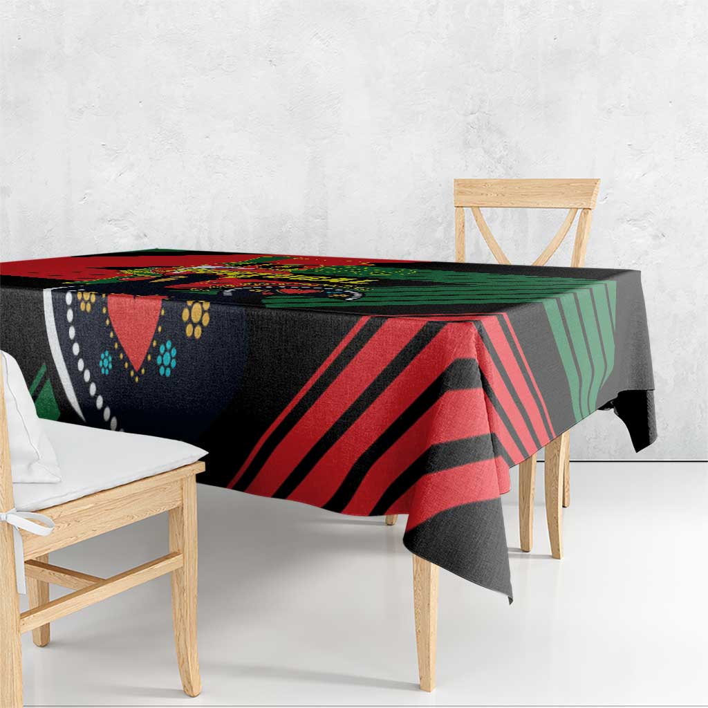 Black tablecloth draped over table edge with red and green diagonal chevrons