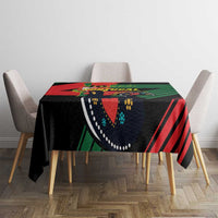 Black tablecloth on dining table with Portugal crest and red-green stripe pattern