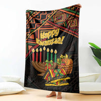 Black Happy Kwanzaa blanket with candles and gift basket print, draped on couch