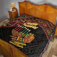 Black quilt on bed with Happy Kwanzaa text, candles, and basket gift illustration