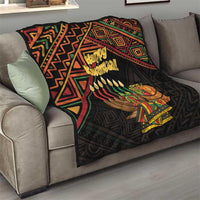 Black quilt on sofa with Happy Kwanzaa graphic, candles, and gift illustrations