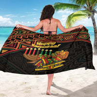 Black sarong with colorful geometric print and 'Happy Kwanzaa' on back