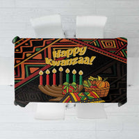Black Kwanzaa tablecloth with 'Happy Kwanzaa' and seven candles on geometric print.