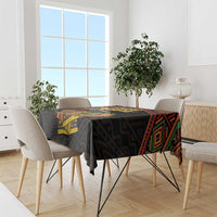 Black Kwanzaa tablecloth with colorful geometric border and 'Happy Kwanzaa' center print.