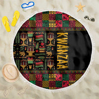 Round beach blanket with Kwanzaa text and colorful African patterns, black center, fringe edge