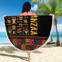 Round beach blanket held out, black center with colorful African Kwanzaa text and white fringe