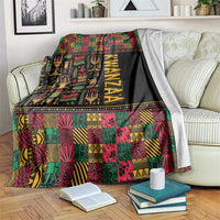 Kwanzaa African pattern blanket in black with colorful geometric blocks and bold KWANZAA stripe