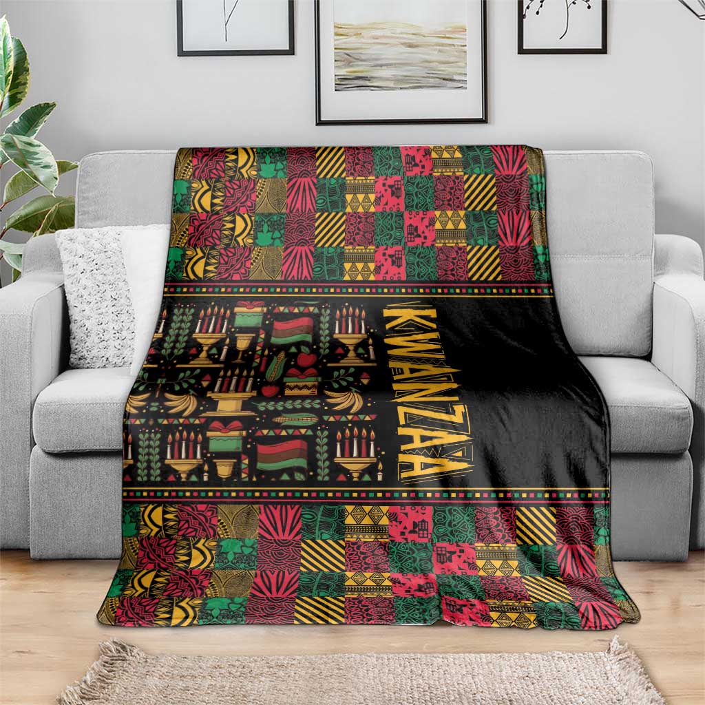 Kwanzaa African pattern blanket draped on a sofa, black with colorful geometric squares and KWANZAA