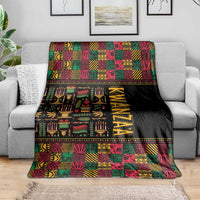 Kwanzaa African pattern blanket draped on a sofa, black with colorful geometric squares and KWANZAA