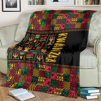 Kwanzaa African pattern blanket on an armchair, black field with colorful tiles and KWANZAA print