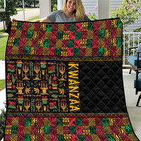 Kwanzaa quilt with black quilted center, multicolor geometric bands and 'KWANZAA' text