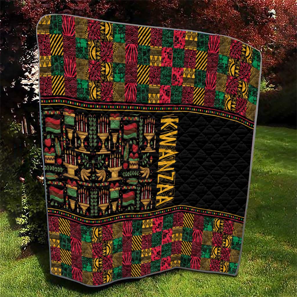 Kwanzaa quilt with black quilted field, multicolor African pattern blocks and border