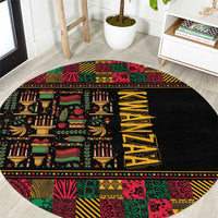 Round black area rug with colorful African pattern borders and yellow vertical text design