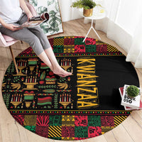 Round black rug with colorful African motifs, candle and banana icons, and yellow vertical letters