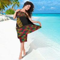 Black African pattern sarong worn to the side, bold multicolor geometric print