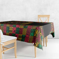 Black tablecloth with colorful African patchwork print and draped corner over bench