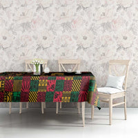Black tablecloth with vibrant multicolor African-inspired patchwork print on dining table