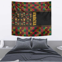 Kwanzaa-themed tapestry with black center, vertical gold “KWANZAA,” and patchwork pattern