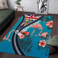 Turquoise area rug with flamingos, tropical leaves, hibiscus blooms, and zipper-style border
